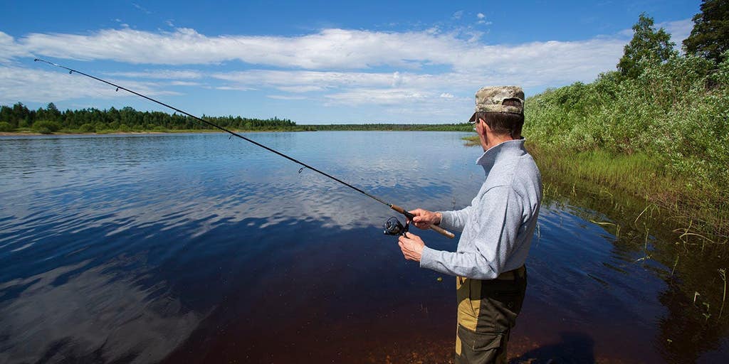 Bear tries to steal one too many fish off of fisherman's line, gets charged at with pole in hand