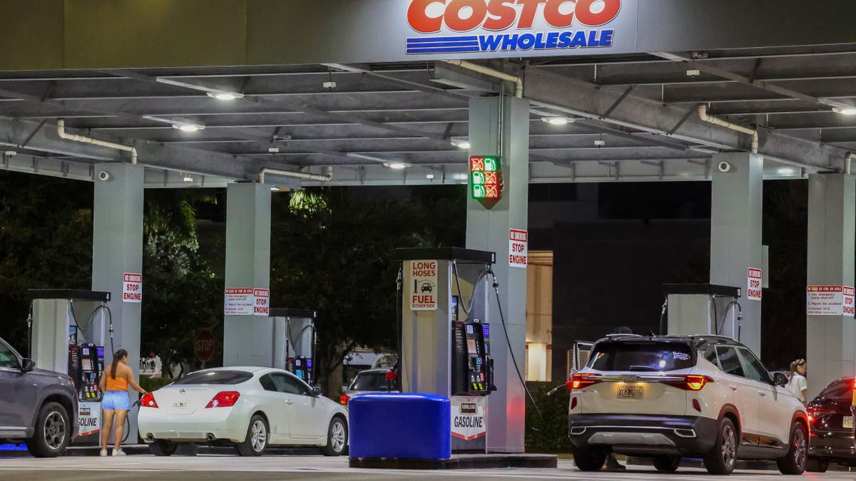 Drivers refuel vehicles at a Costco gas station in North Miami Beach.