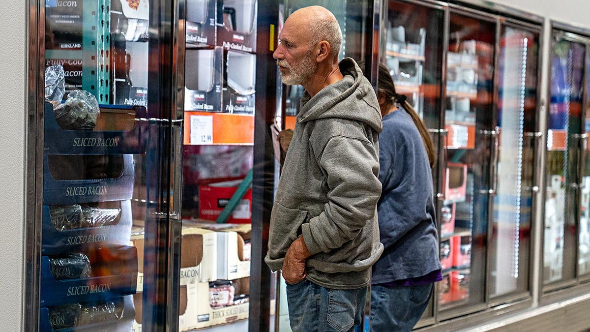 A couple looks at a frozen food display in a Costco Wholesale store.