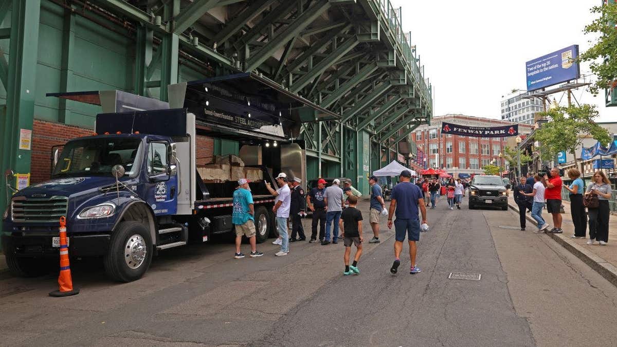 fans observe the section of the south tower on display at Fenway Park