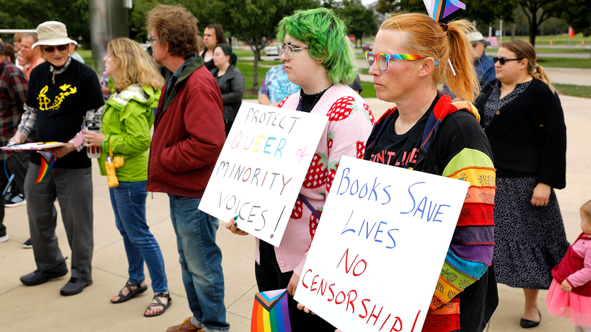 Demonstrators protest school book restrictions outside Michigan library.