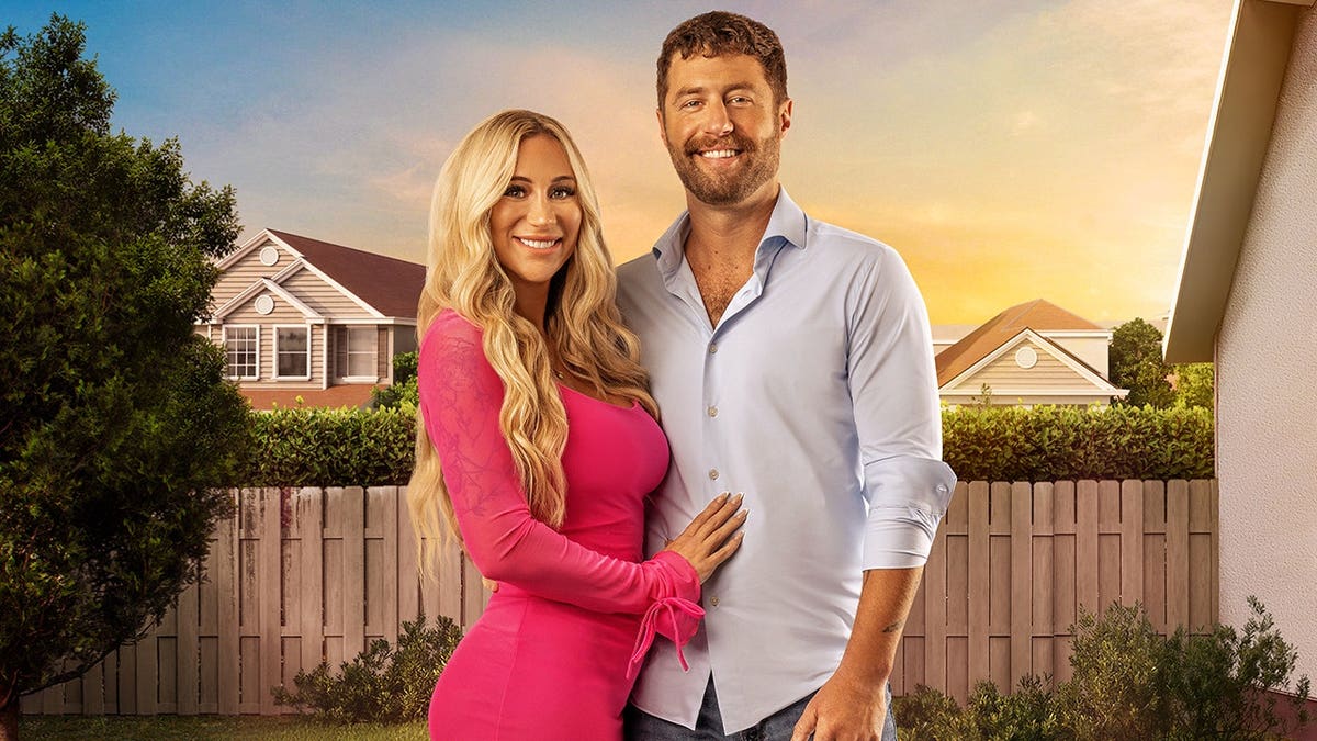 Brianna and her husband Phil pose for a press shot for