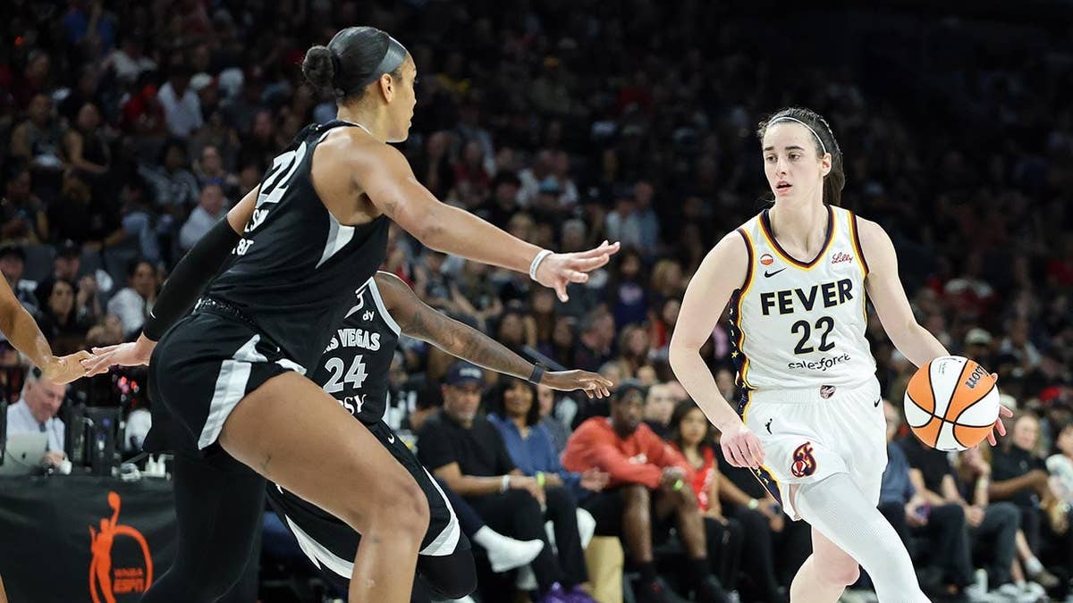 A'ja Wilson playing defense against Caitlin Clark during a WNBA playoff game