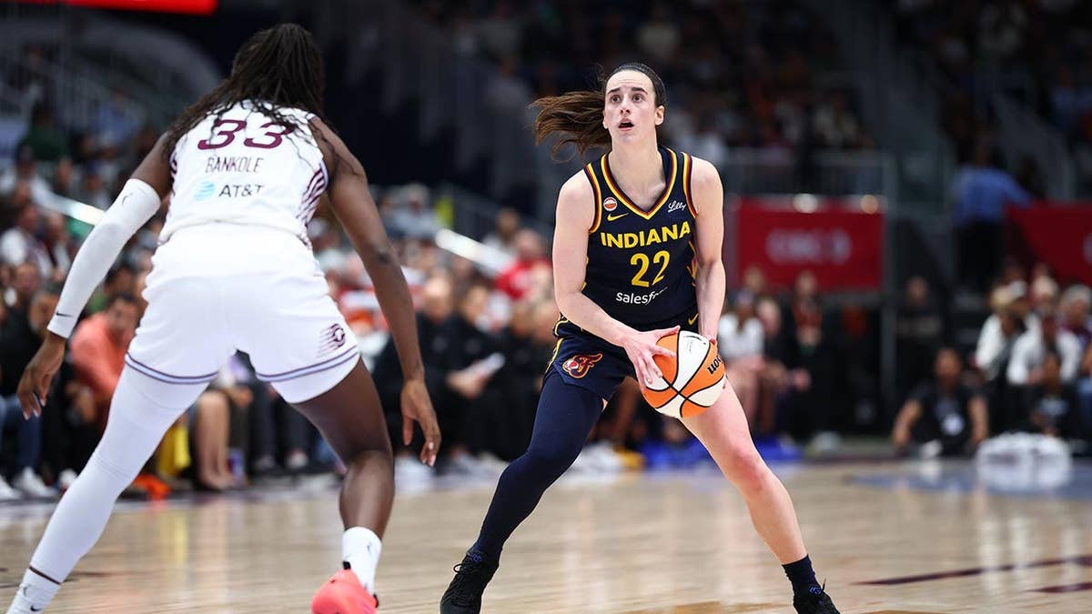 Caitlin Clark handling the ball during a WNBA game