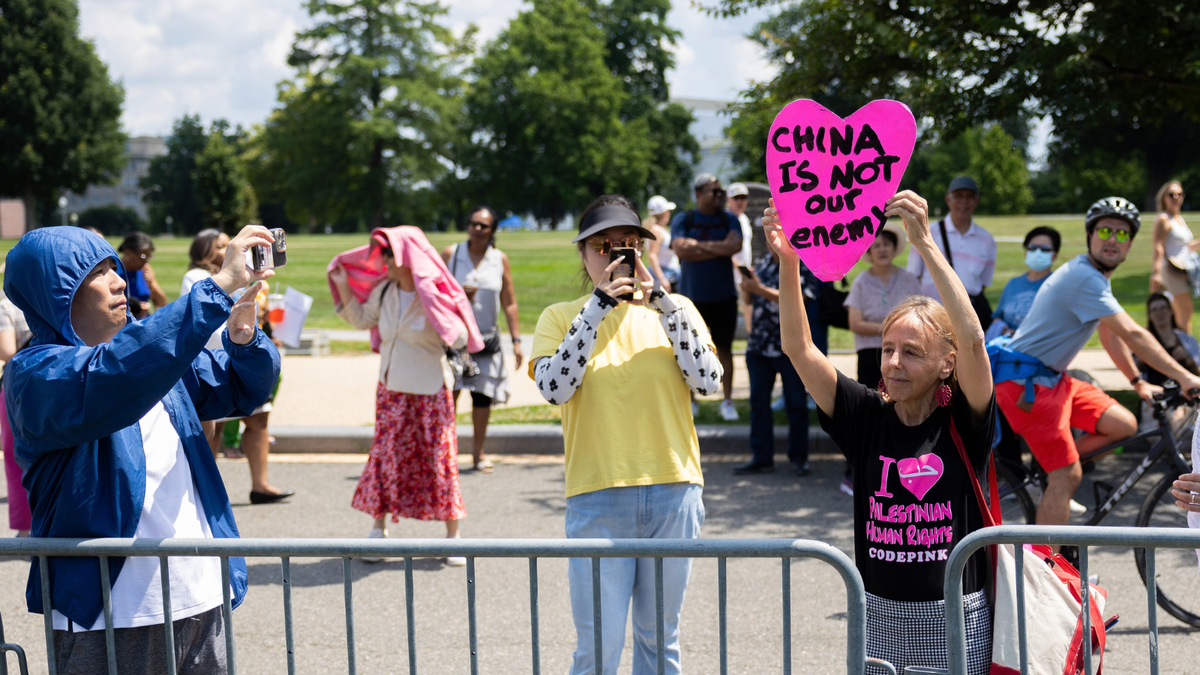 CodePink co-founder Medea Benjamin holds up a poster from a campaign the nonprofit started, called 