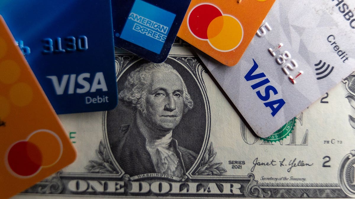 Credit cards laying on a dollar bill.