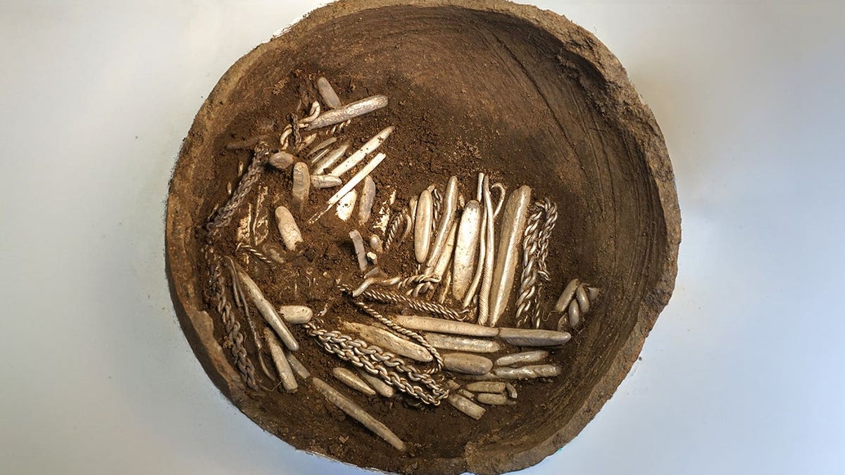 View of clay pot with silver treasure