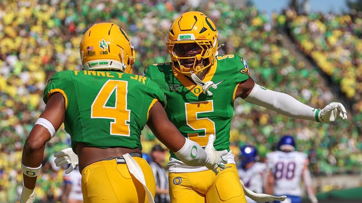 Davon Benjamin and Brandon Finney Jr. celebrate a play during a college football game