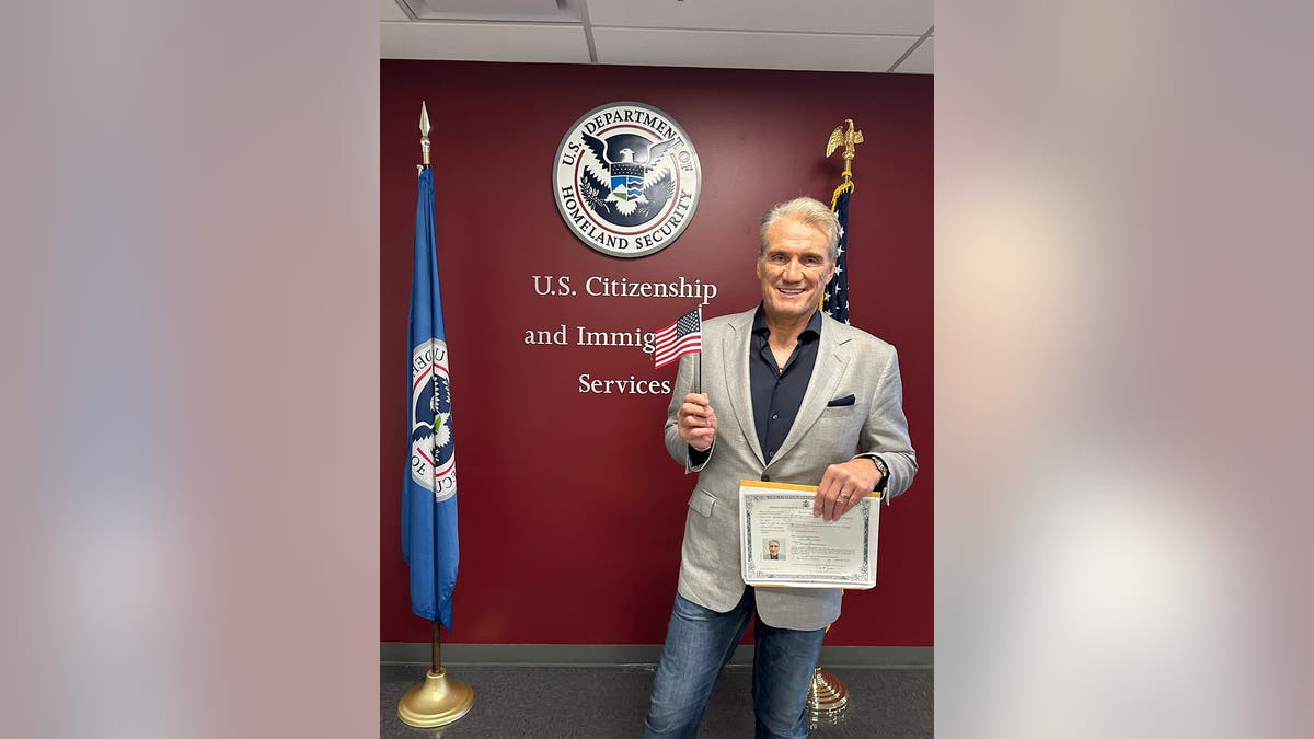 Dolph Lundgren holding an American flag after becoming a U.S. citizen.