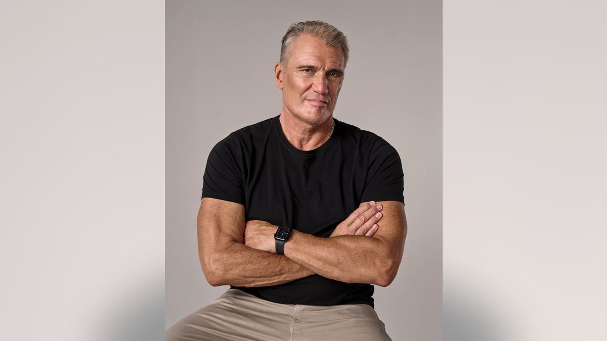 Dolph Lundgren wearing a black shirt.