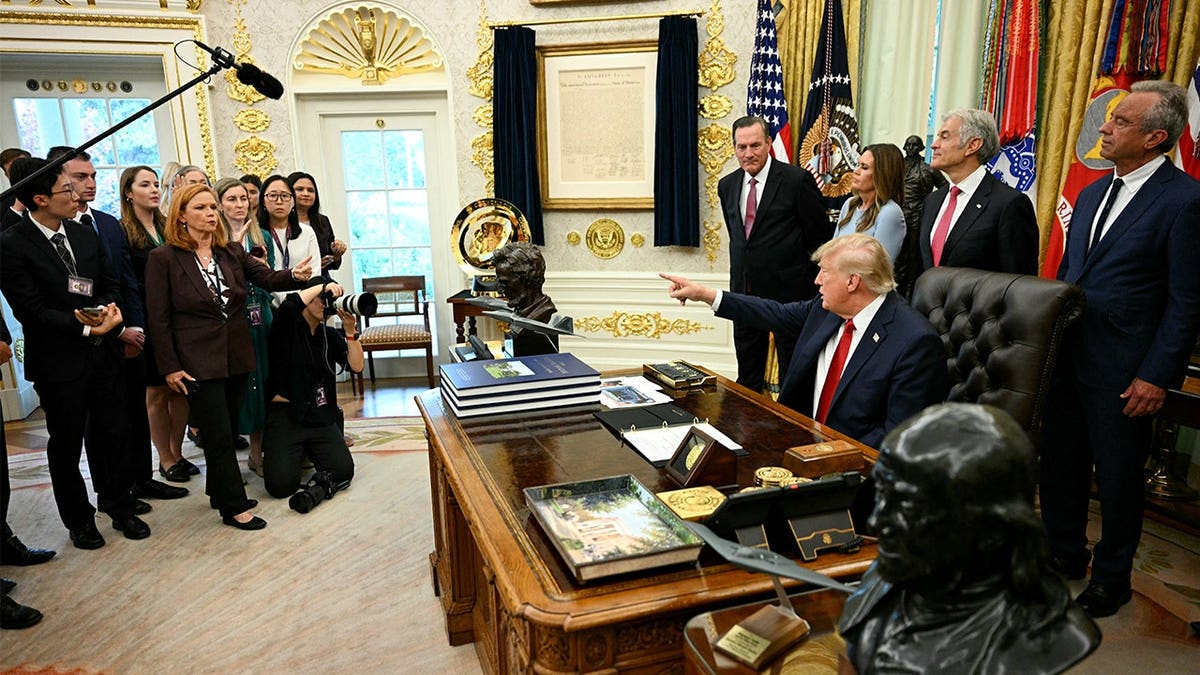 Donald Trump takes questions from reporters in Oval Office