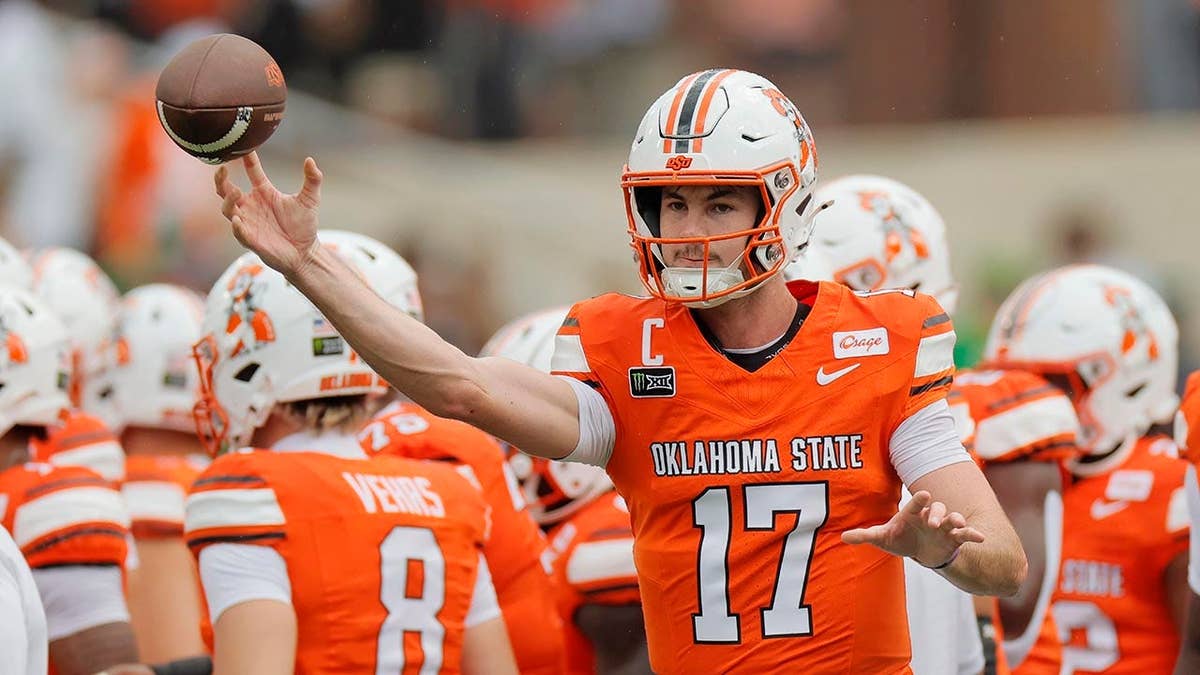 Oklahoma State quarterback throwing a pass