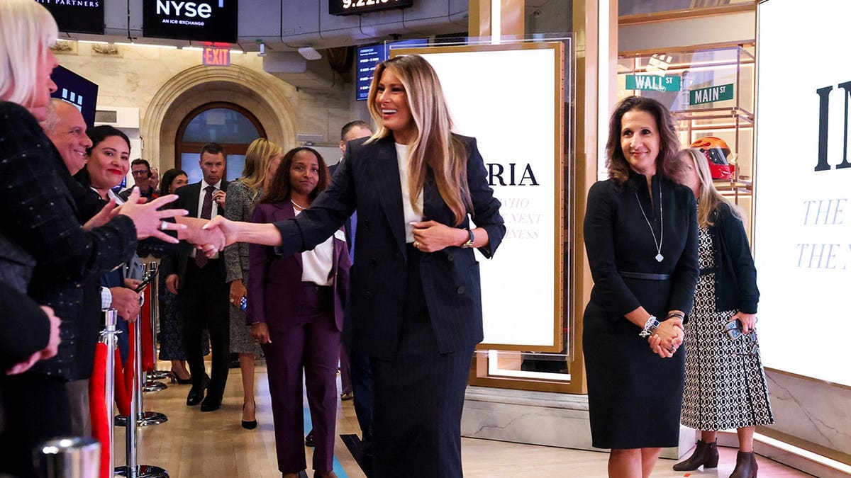 US First Lady Melania Trump, flanked by President of NYSE Group Lynn Martin, walks after ringing the New York Stock Exchange (NYSE) opening bell, in New York City, US, September 23, 2026.