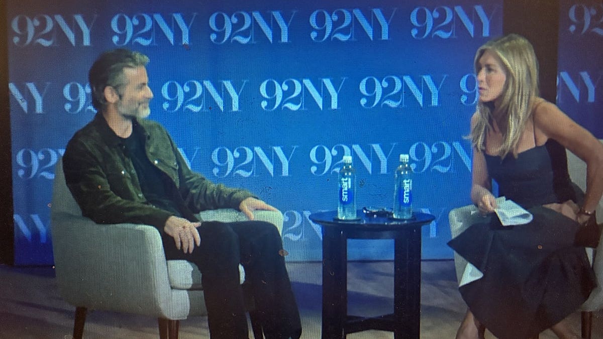 Jennifer Aniston interviewing Jim Curtis at an event for his new book on Wednesday.