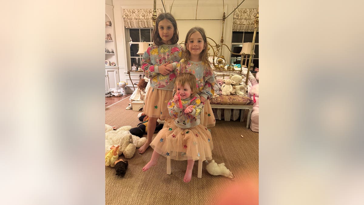 Jaclyn Smith's granddaughters posing in matching dresses.