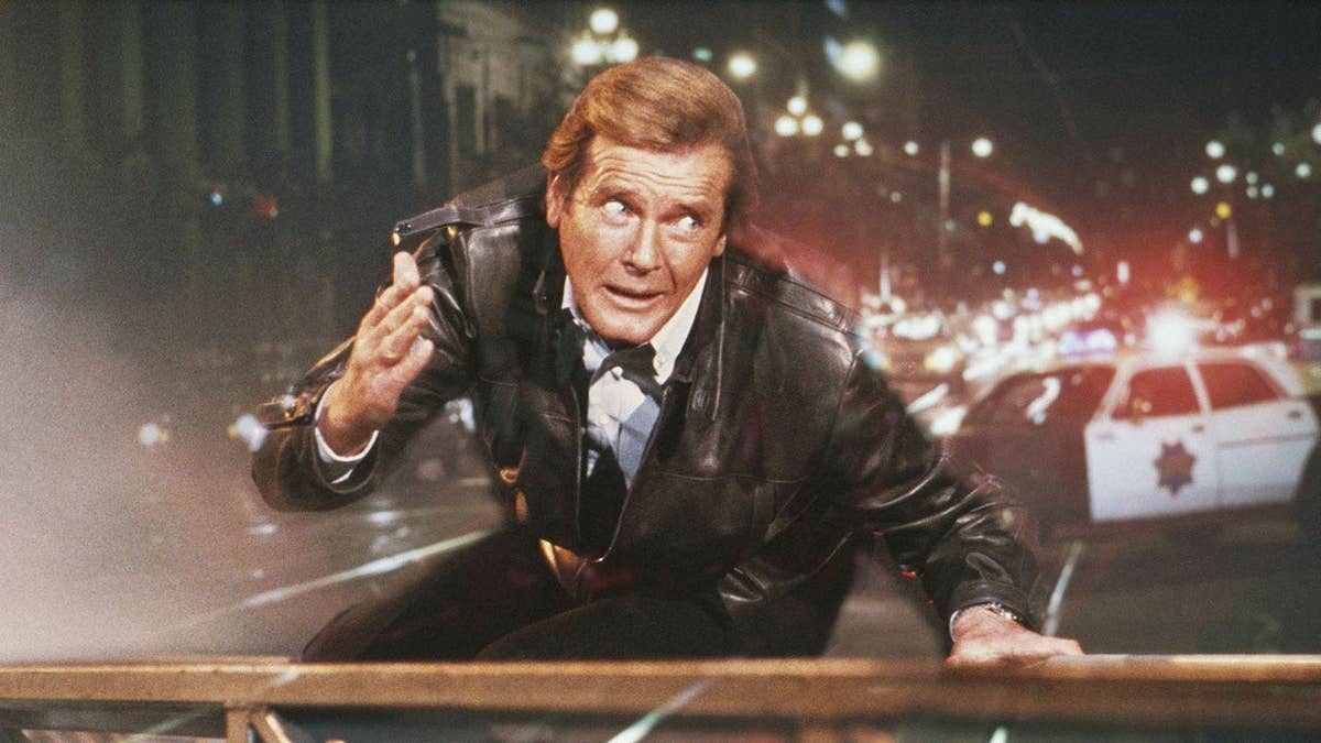 Roger Moore acting out a scene in a suit as James Bond.