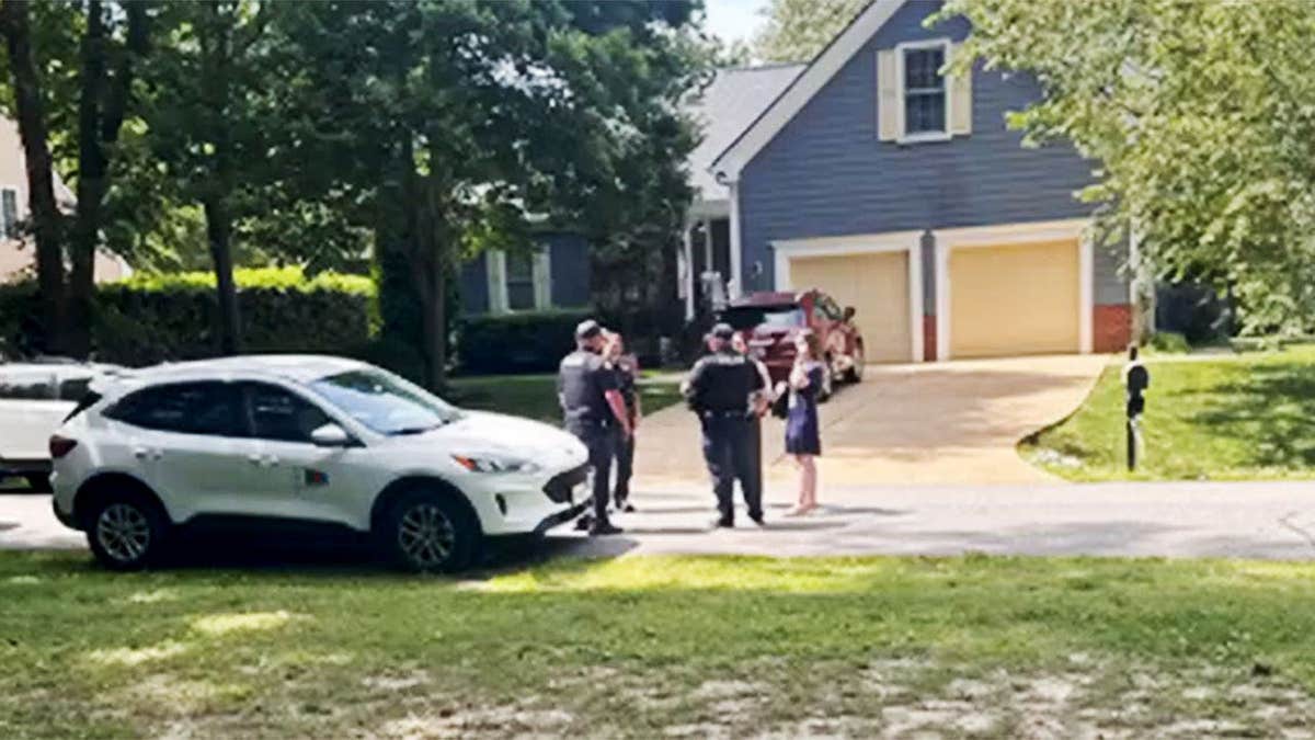 Police outside Karyann Parkinson's home.