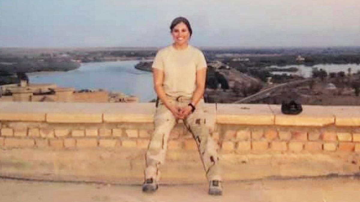 Lindsey Schmidt in Army wear near the Tigris River.