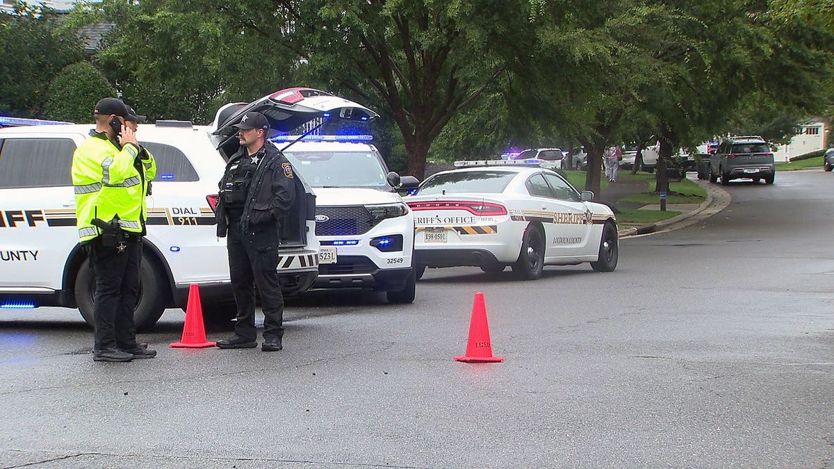 Loudoun County Sheriff's Office vehicles and deputies at the scene of a fatal shooting in Aldie, Virginia.