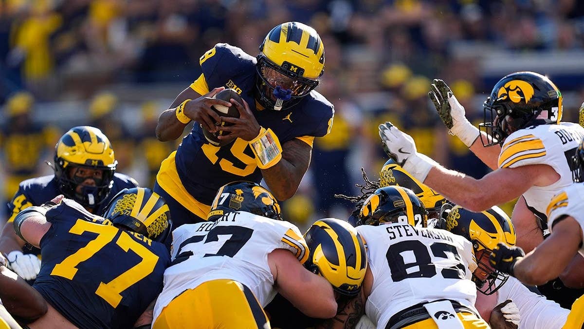Bryce Underwood leaping during a college football game