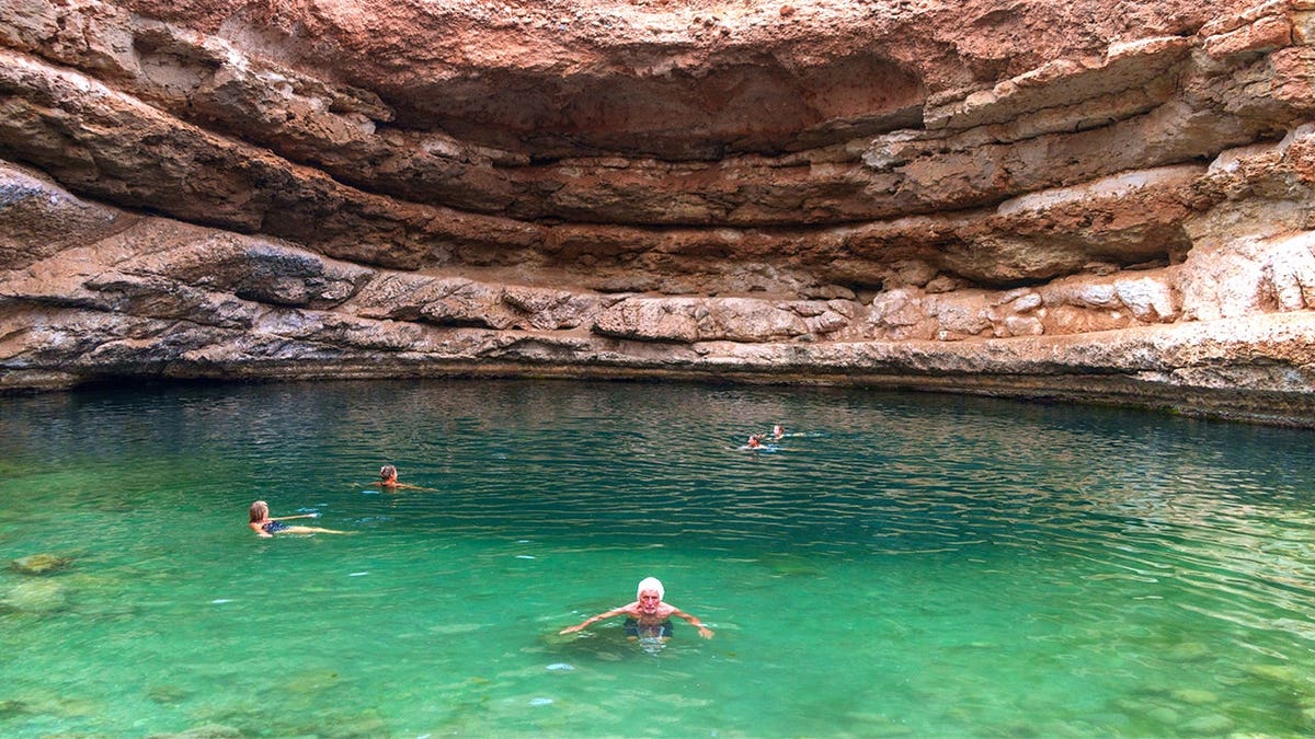 Man bathing in pool in Oman