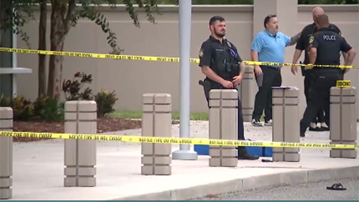 Police stand near Port Orange Police Department building