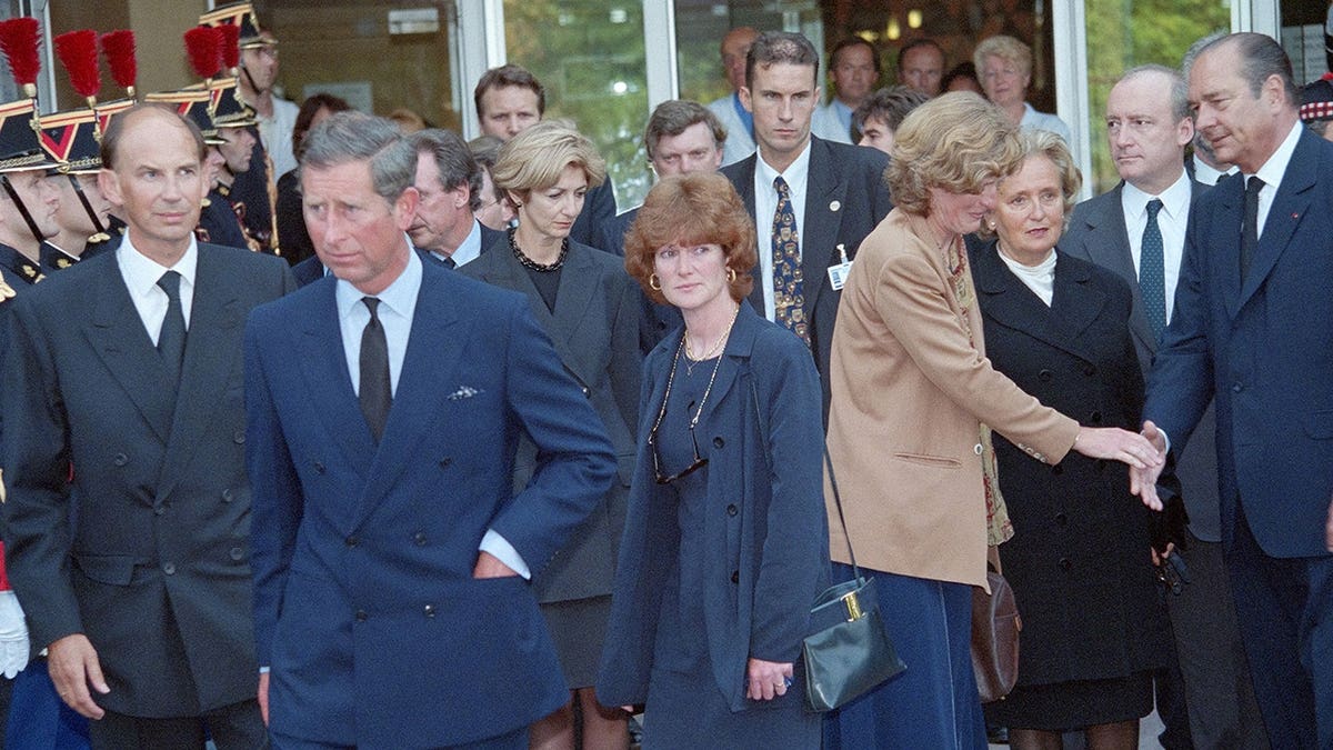 Prince Charles shakes hands with French President Jacques Chirac outside a hospital in Paris.
