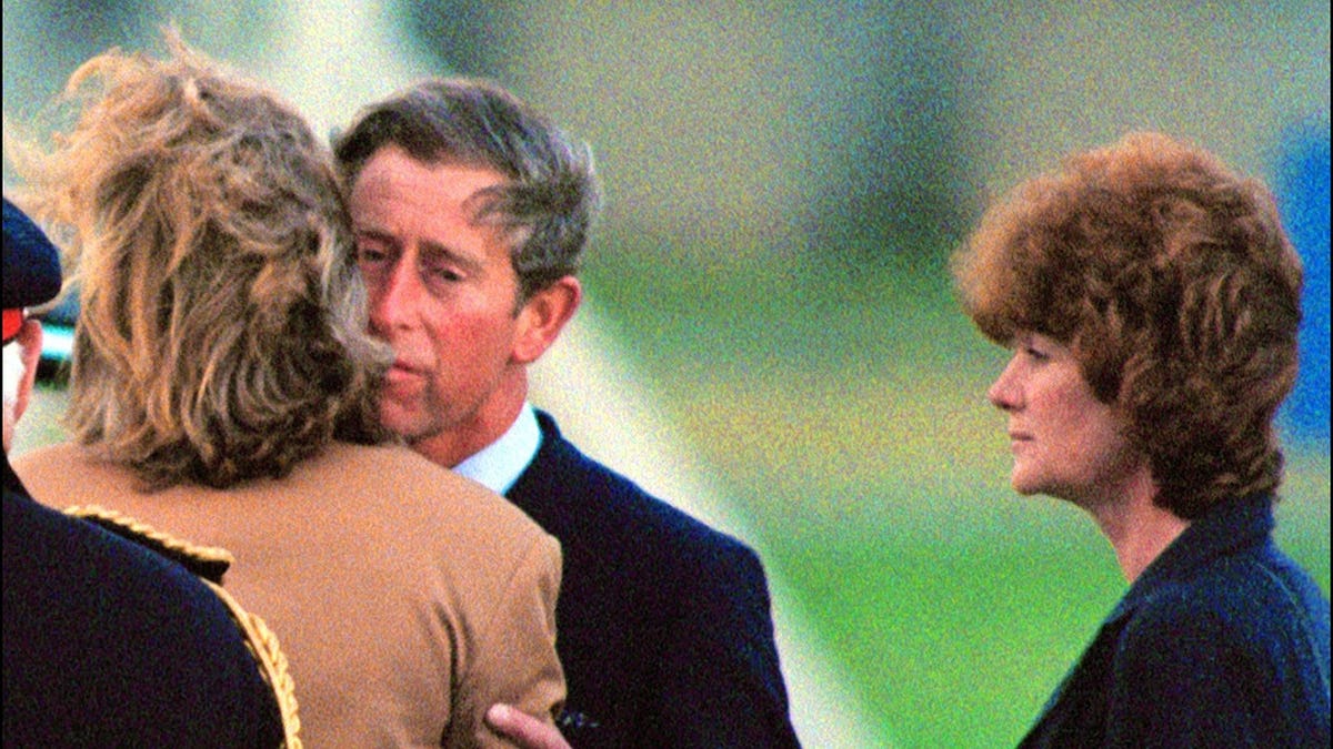 Prince Charles kisses Lady Sarah McCorquiodale as Lady Jane Fellows looks on.