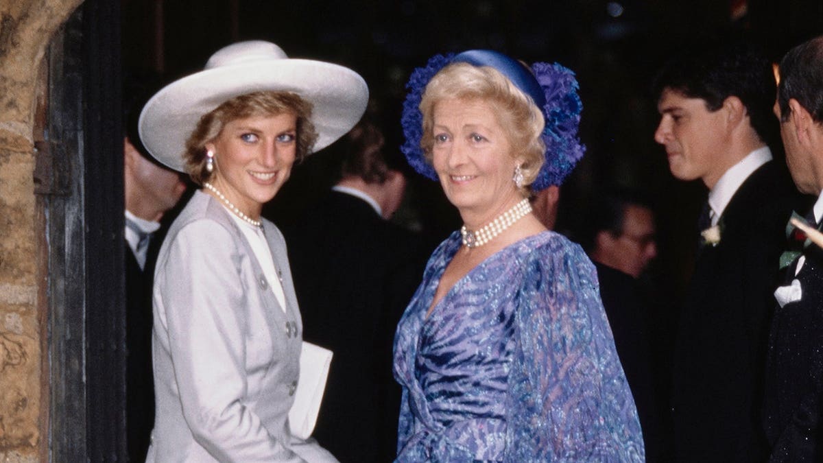 Diana, Princess of Wales, stands with her mother Frances Shand Kydd at a church wedding.