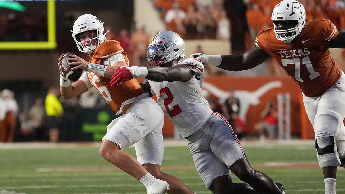 Arch Manning is sacked by Kenyatta Jackson Jr. during a college football game in Austin.