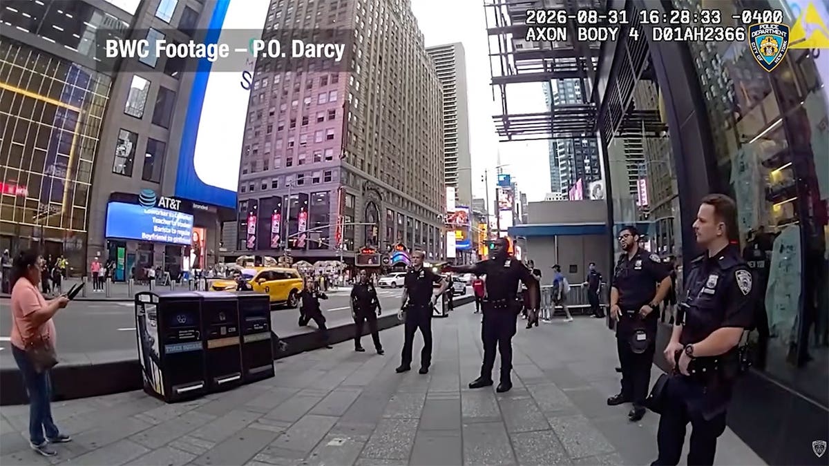 NYPD body camera image shows an officer speaking with a woman holding two knives during a Times Square standoff.