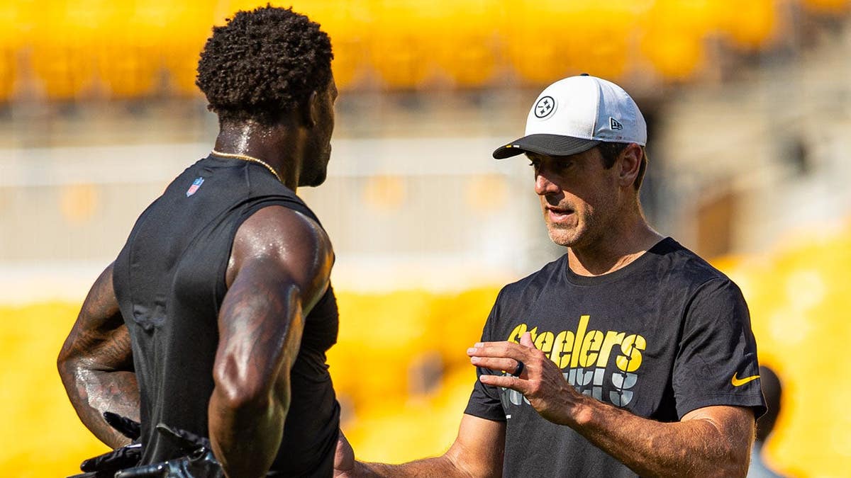 Aaron Rodgers talks to DK Metcalf during pregame before a preseason football game.