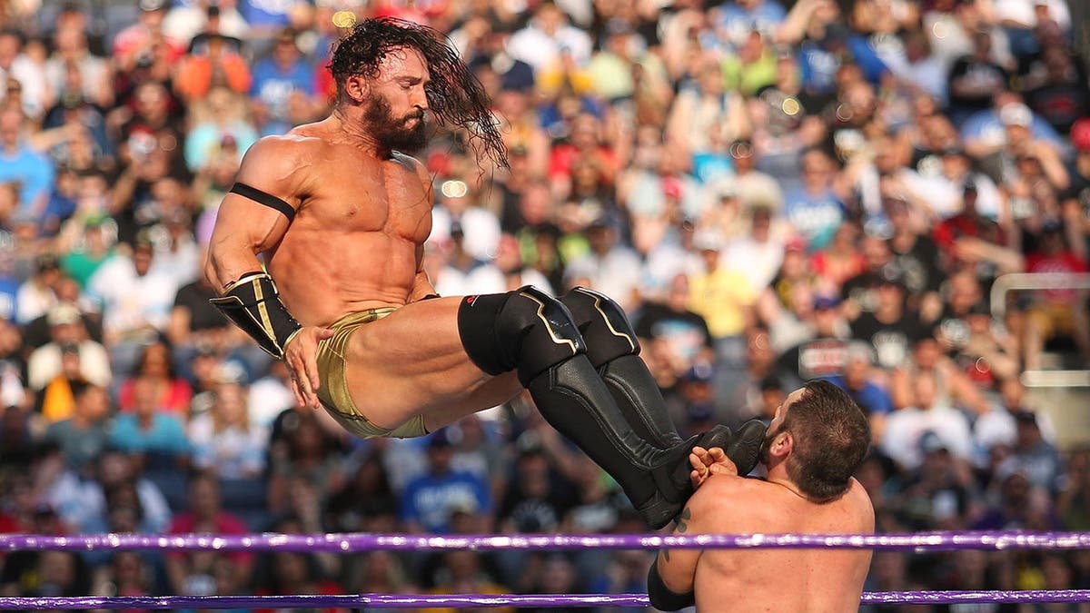 Adrian Neville kicks Austin Aries during WrestleMania 33 in Orlando, Fla.