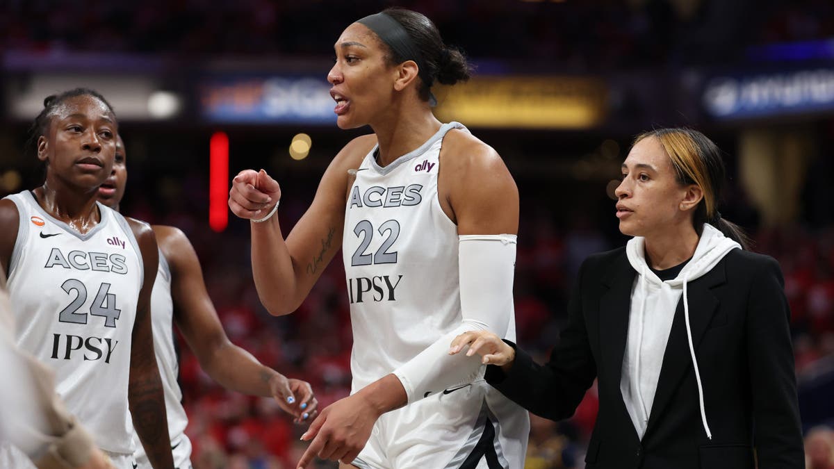 A'ja Wilson of the Las Vegas Aces stands visibly upset after entering the stands during a WNBA playoff game against the Indiana Fever.