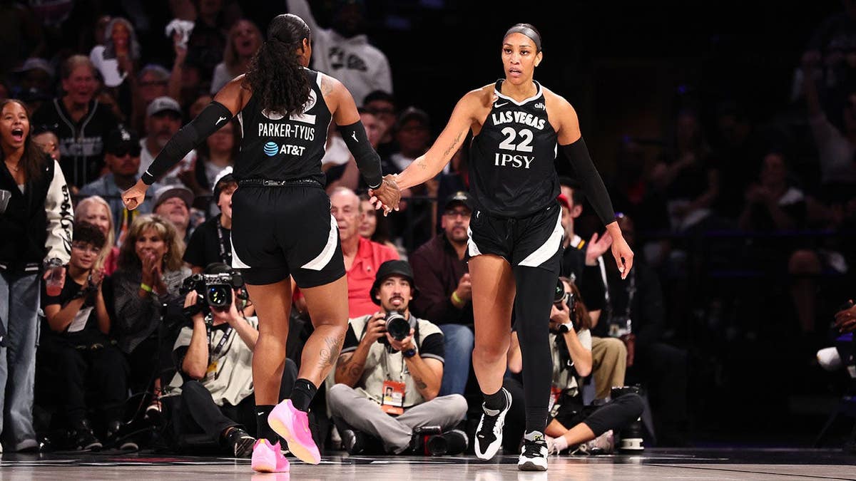 A'ja Wilson high-fives Cheyenne Parker-Tyus during a WNBA playoff game.