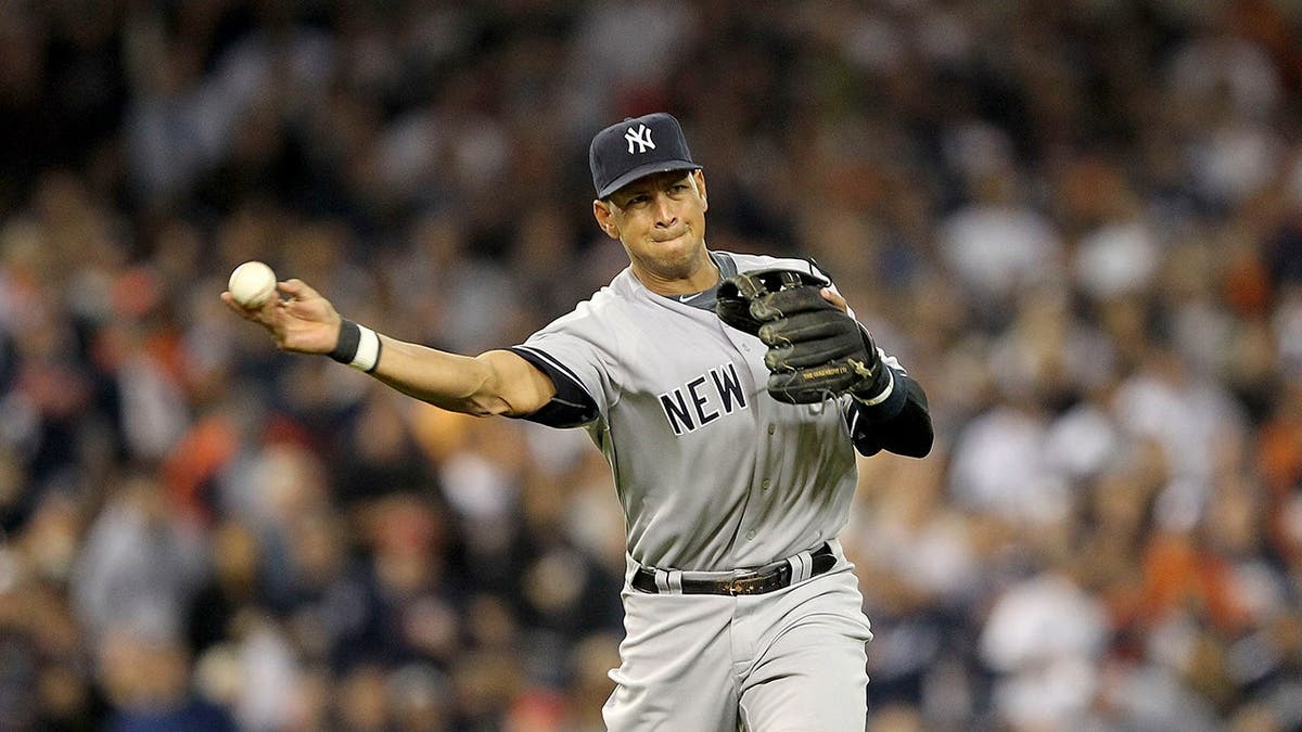 Alex Rodriguez throws a baseball while playing for the Yankees.