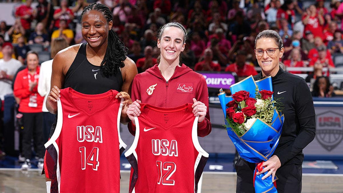 Aliyah Boston, Caitlin Clark and Stephanie White stand on the court during a Team USA honor ceremony.