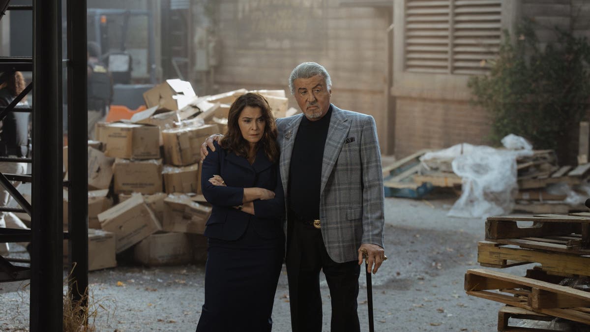 Annabella Sciorra and Sylvester Stallone stand together in a scene from Tulsa King season 4.