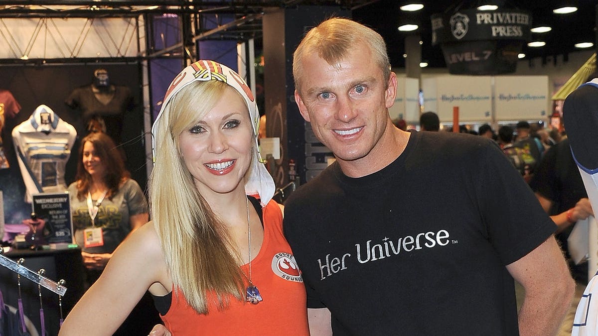 Ashley Eckstein and David Eckstein stand at a Star Wars clothing display.
