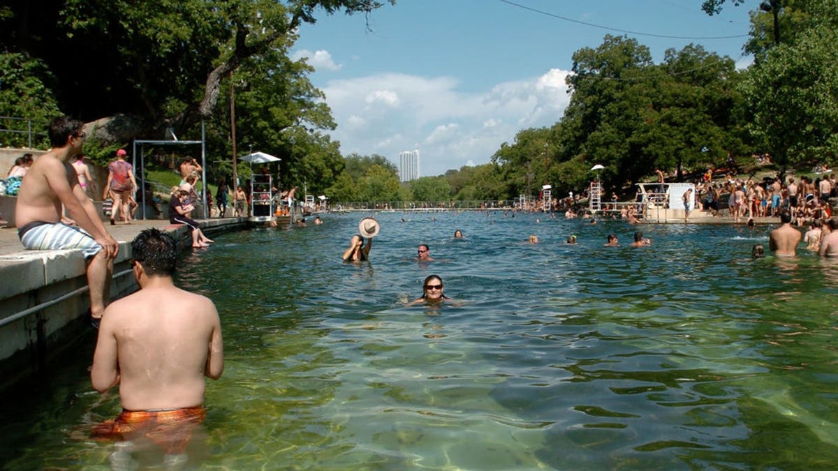 Parkgoers swim in Barton Springs Pool at Zilker Park in Austin, Texas.