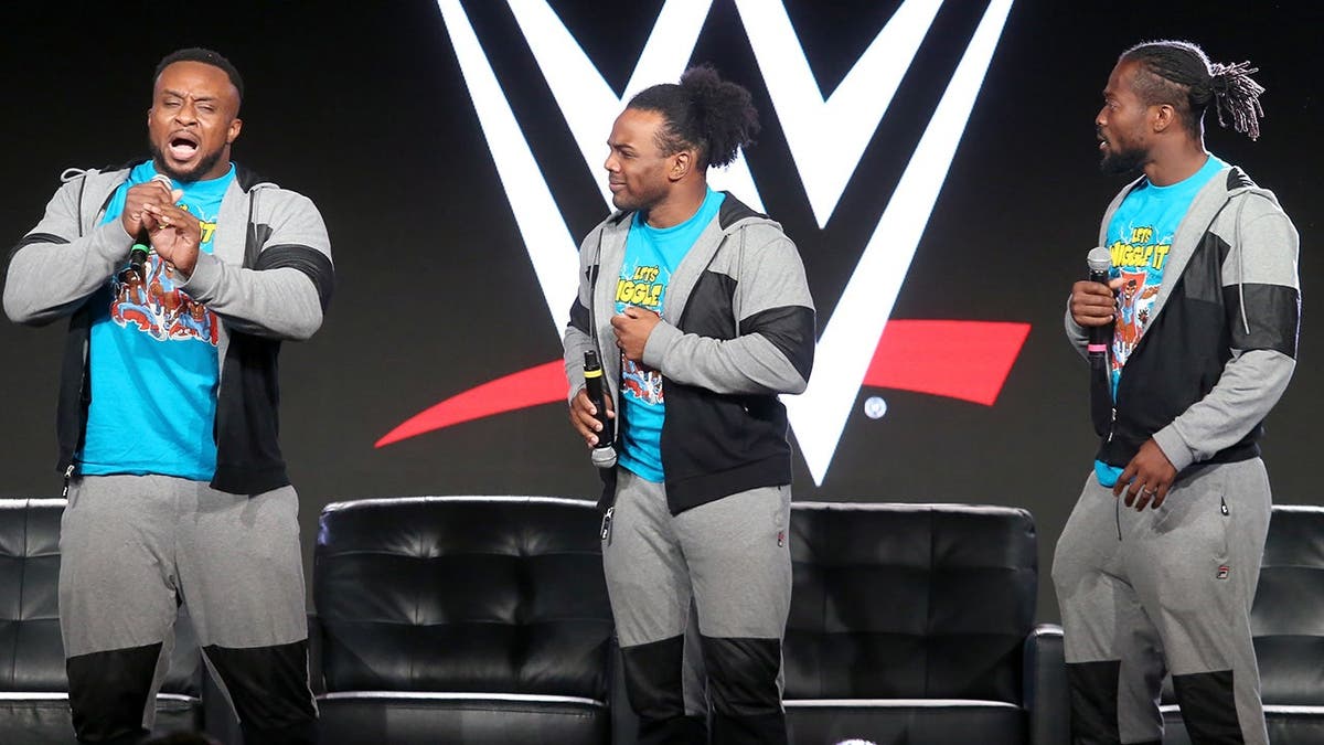 Big E, Xavier Woods and Kofi Kingston of The New Day speak onstage during a press tour event.