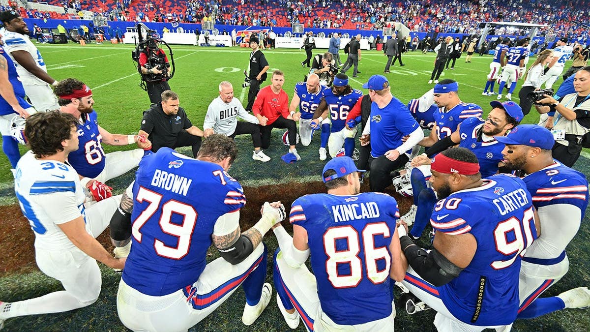 Buffalo Bills and Detroit Lions players pray together after the game at New Highmark Stadium.