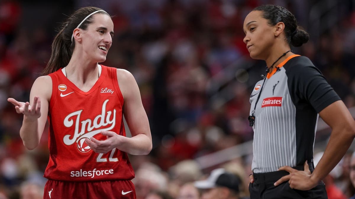 Caitlin Clark talks with a referee during a game at Gainbridge Fieldhouse.
