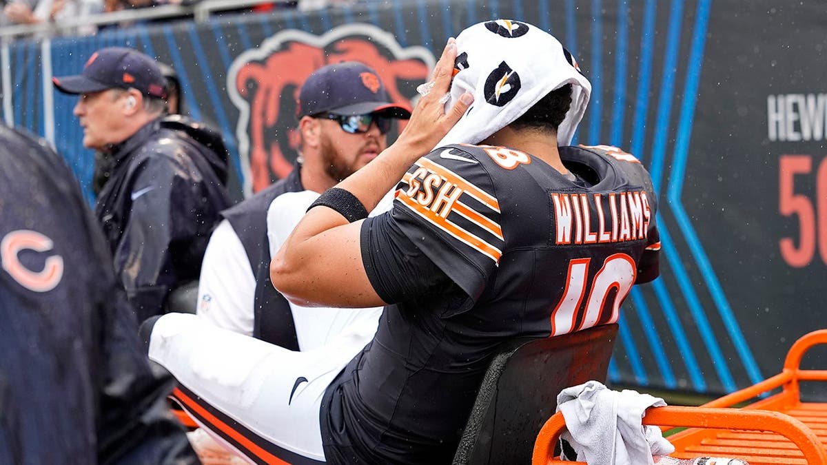 Caleb Williams is carted off the field after an injury at Soldier Field.