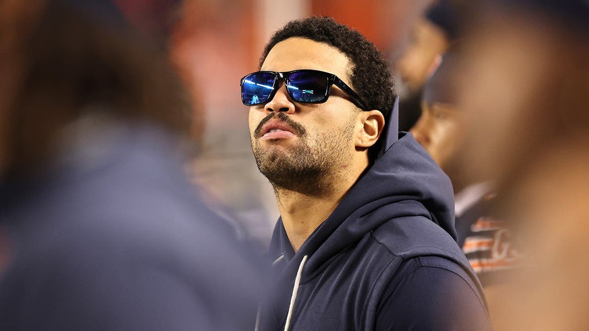 Caleb Williams stands on the sideline during a Bears game at Soldier Field.