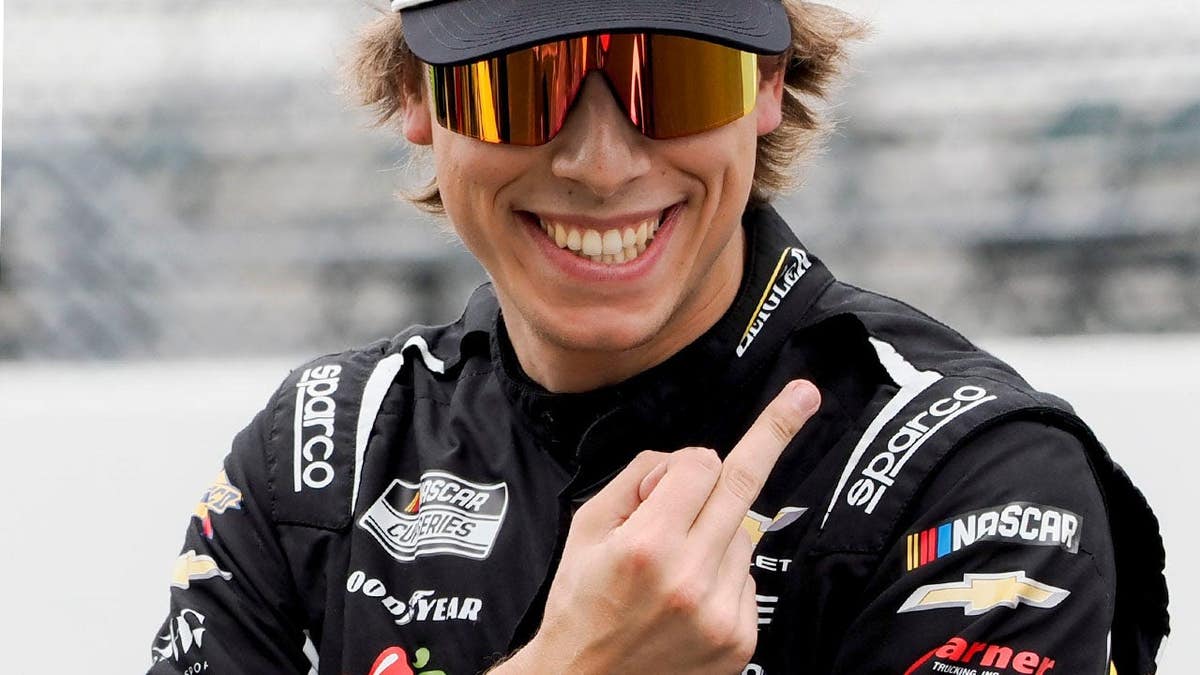 Carson Hocevar gestures toward Daniel Suarez during NASCAR qualifying at Indianapolis Motor Speedway.