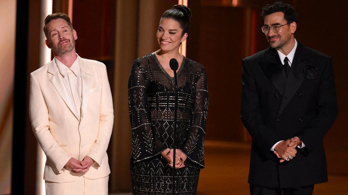 Macaulay Culkin on stage with Dan Levy and Annie Murphy
