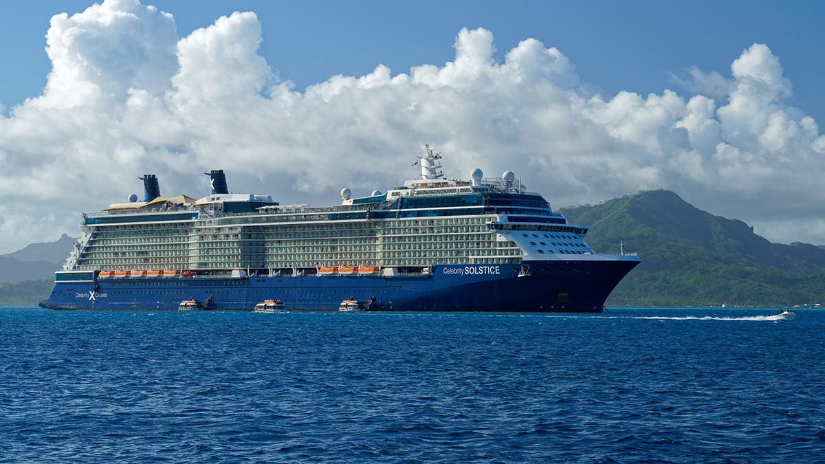 Celebrity Solstice cruise ship anchored in lagoon between Raiatea and Tahaa.