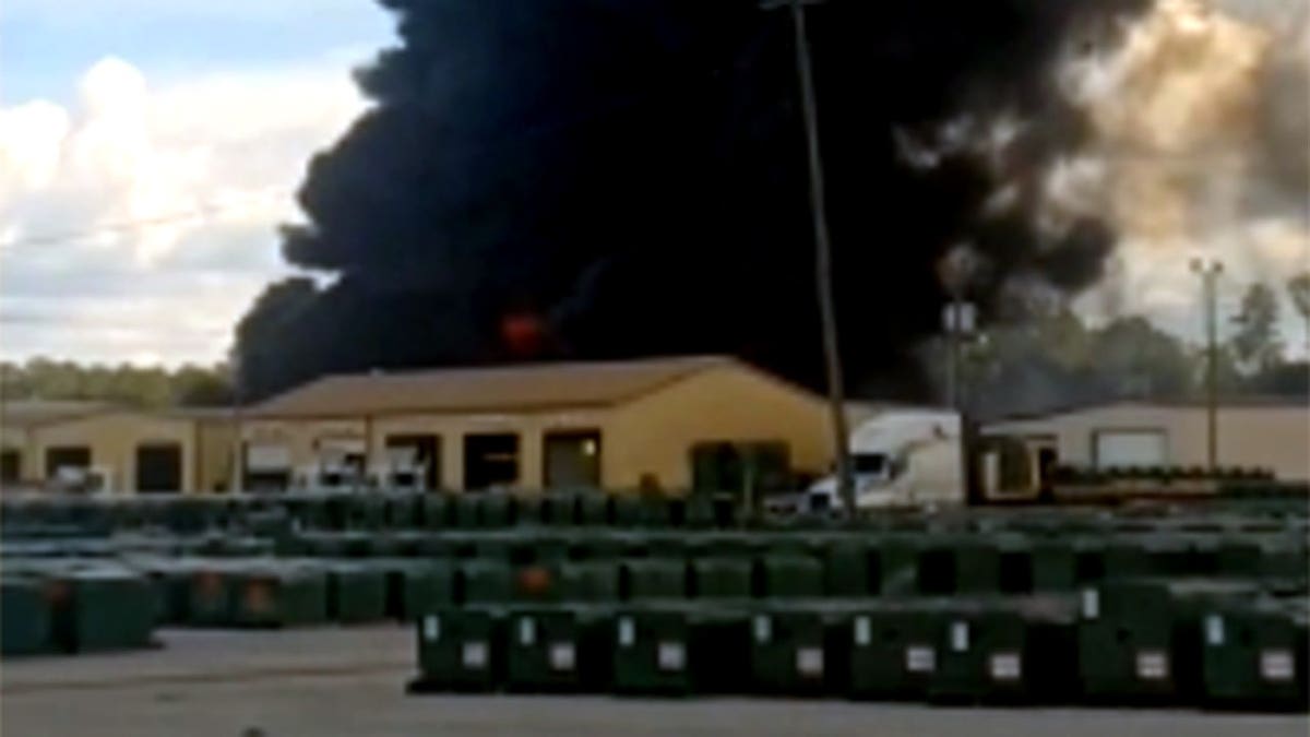 black smoke billowing from facility