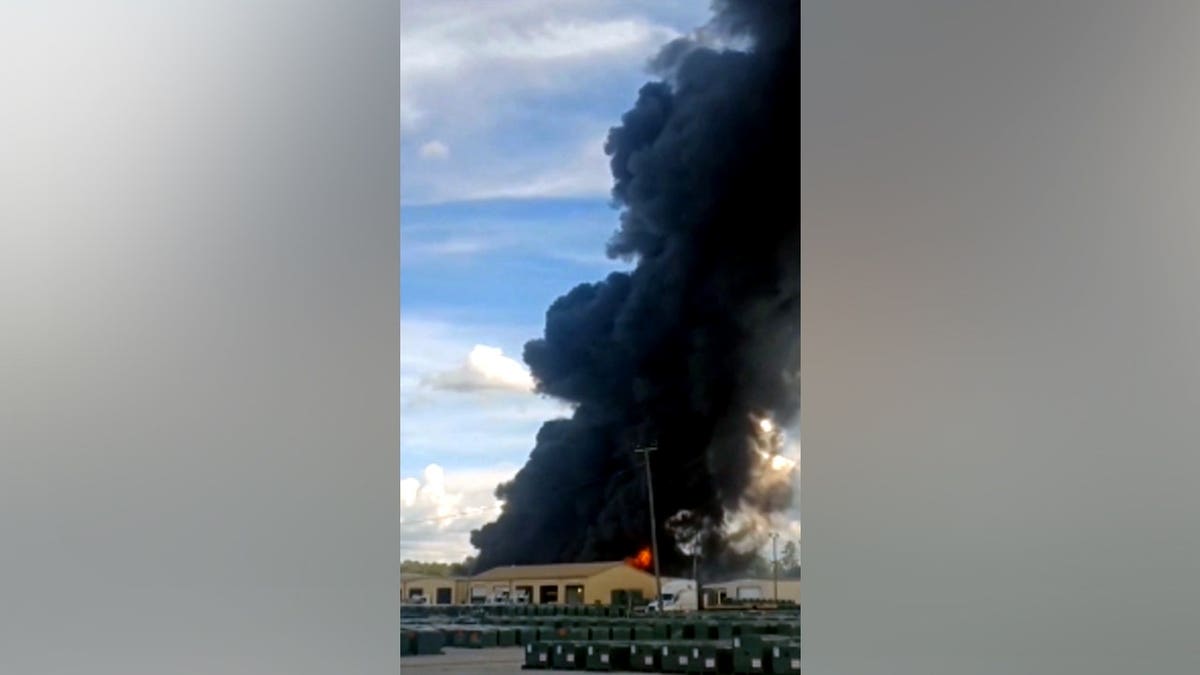 black smoke billowing from facility